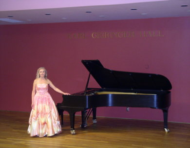Mari standing by piano after her UCSB recital